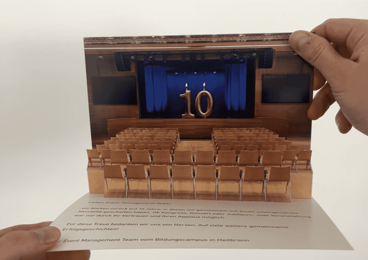 Architectural popup invitation card showing Bildungscampus buildings